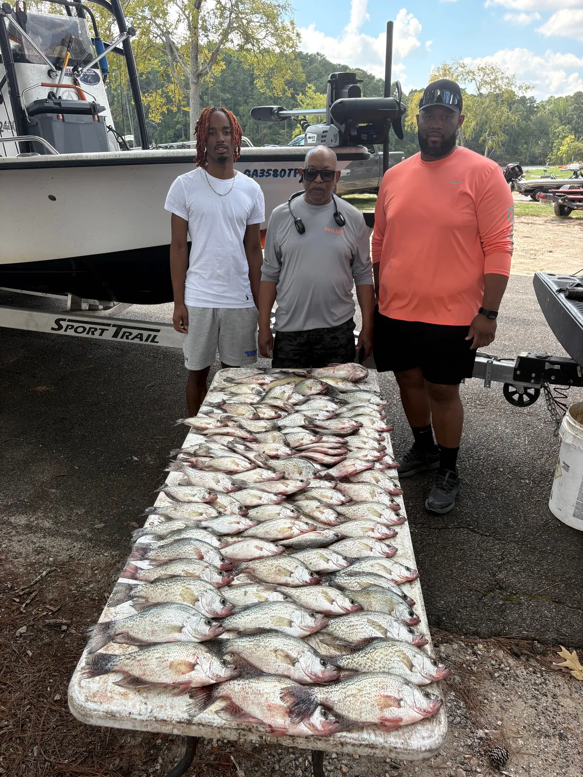Three people fishing at Thomson